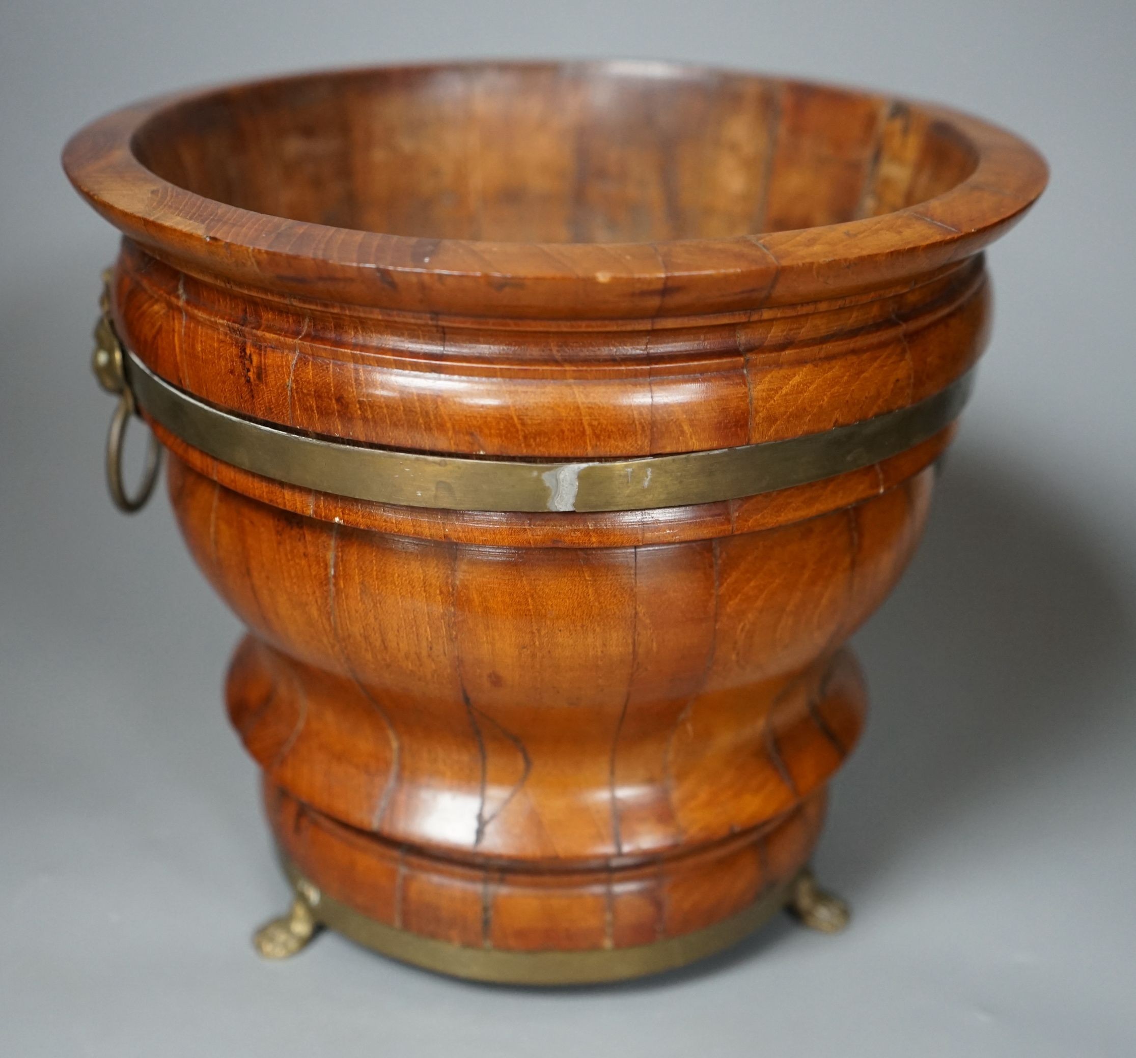 A 19th century brass bound coopered planter with loin mask handles, 19cms high